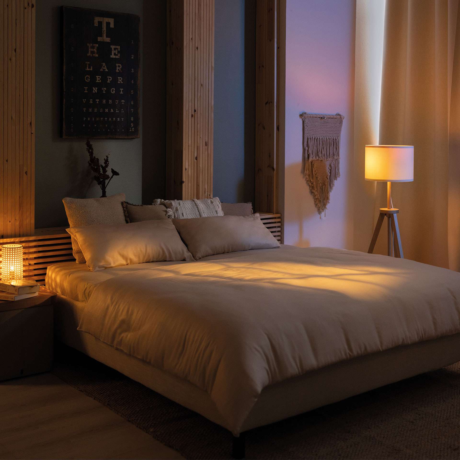 Cozy bedroom with a bed, soft lighting, and decorative wall elements.